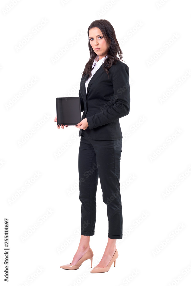 Serious business woman manager holding and showing black empty tablet screen. Full body isolated on white background. Serious business woman manager holding and showing black empty tablet screen. Full body isolated on white background.