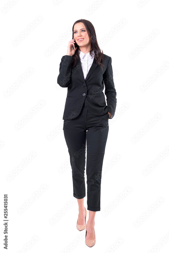 Successful confident happy corporate woman walking and talking on the mobile phone. Full body isolated on white background. Successful confident happy corporate woman walking and talking on the mobile phone. Full body isolated on white background.