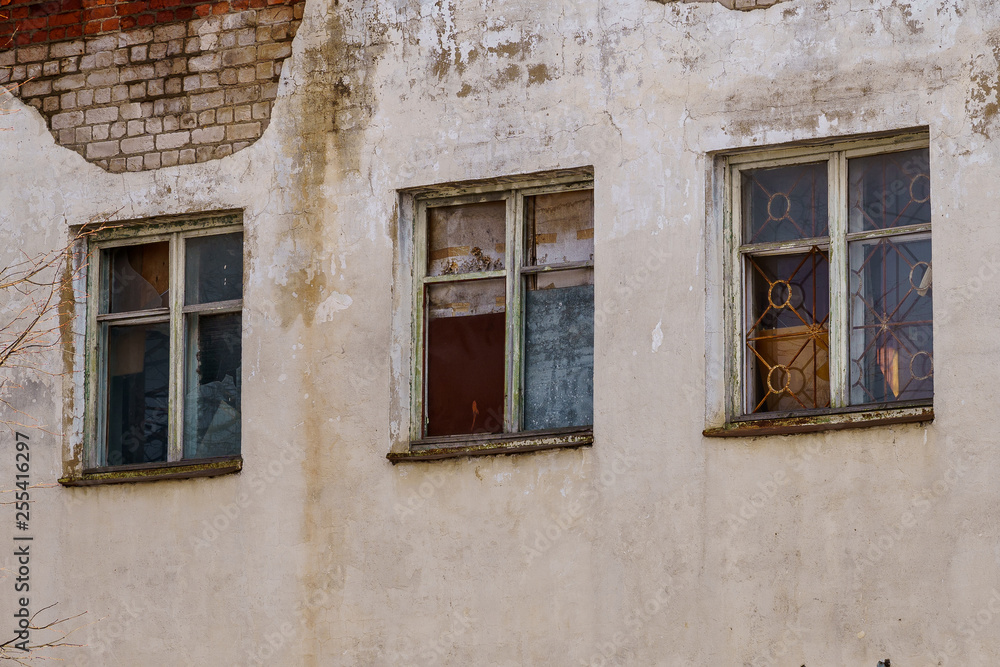 windows in a brick house with a bare facade