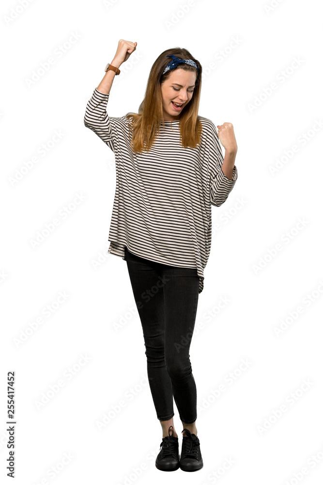 Obraz premium A full-length shot of a Young woman with headscarf celebrating a victory over isolated white background