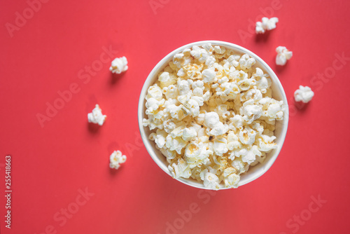 Popcorn viewed from above on red background.