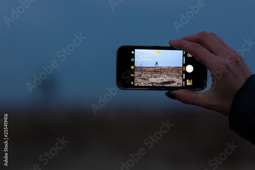 taking photo by mobile, hand holding mobile phone