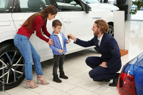 Car salesman working with family in dealership