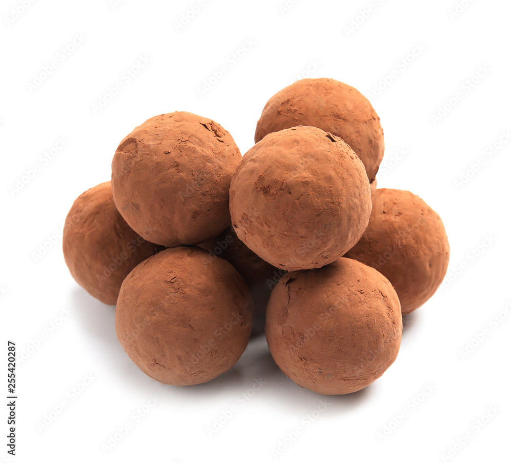 Delicious raw chocolate truffles on white background Delicious raw chocolate truffles on white background