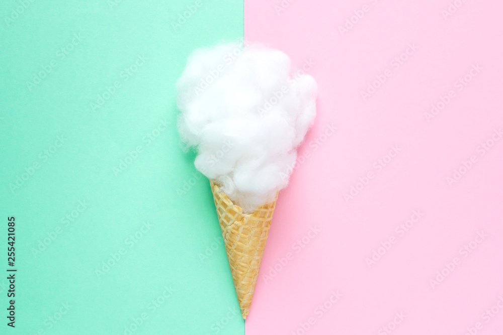 Composition of ice cream cone with pink wisp of bast on a light blue background. Bathroom cosmetic accessories. Flat Lay. Top View Composition of ice cream cone with pink wisp of bast on a light blue background. Bathroom cosmetic accessories. Flat Lay. Top View
