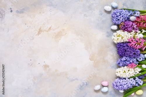 Easter background. Hyacinth flowers and decorative Easter eggs. Copy space, top view.