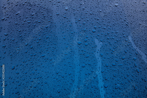 raindrops on blue glass surface