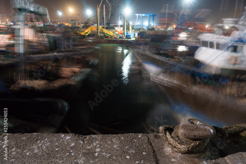 Long Exposure shot in Essaouira port in Morocco. Blured Blue fishing boats of Essaouira at night photo