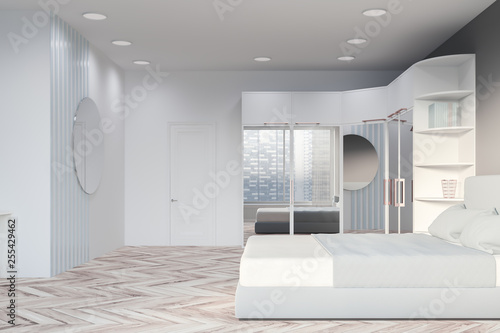 Side view of gray bedroom with wardrobe