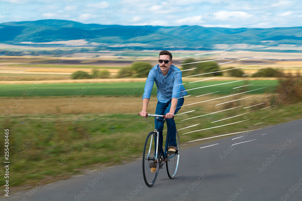 Casual hipster cyclist riding bicycle with high speed concept