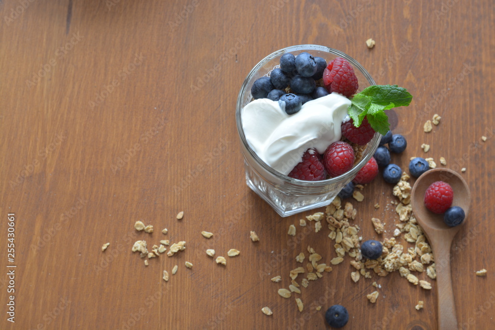 granola in a glass with greek yoghurt, raspberries and blueberries granola in a glass with greek yoghurt, raspberries and blueberries
