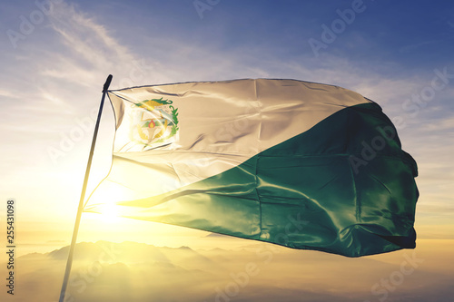 Chiquimula department of Guatemala flag waving on the top sunrise mist fog