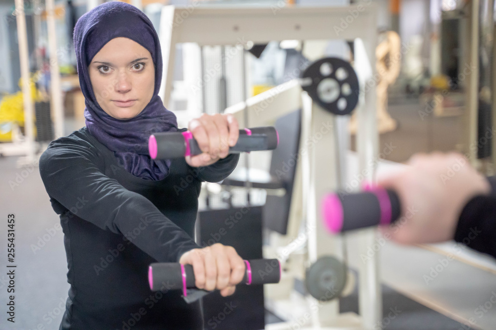 healthy muslim woman with hijab exercising in gym Stock Photo | Adobe Stock