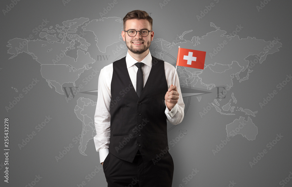 Cheerful businessman standing in front of a map with flag on his hand
Cheerful businessman standing in front of a map with flag on his hand