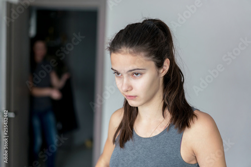 Fototapeta teenager girl listens to the advice of her mother, sitting in her room, conflict