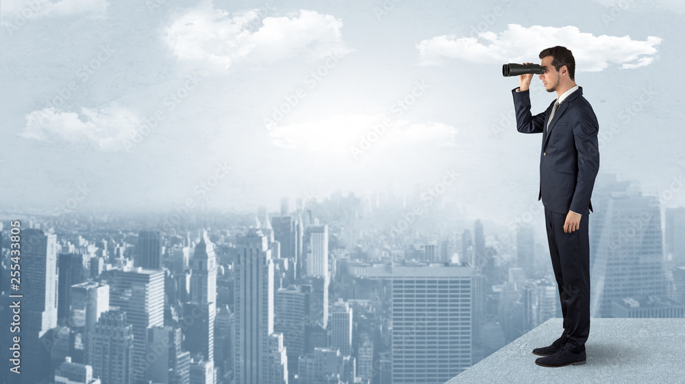 Businessman looking forward to a city with binoculars from skyscraper concept
Businessman looking forward to a city with binoculars from skyscraper concept