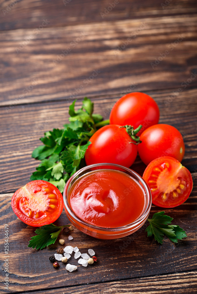 Tomato ketchup sauce on wooden background Tomato ketchup sauce on wooden background