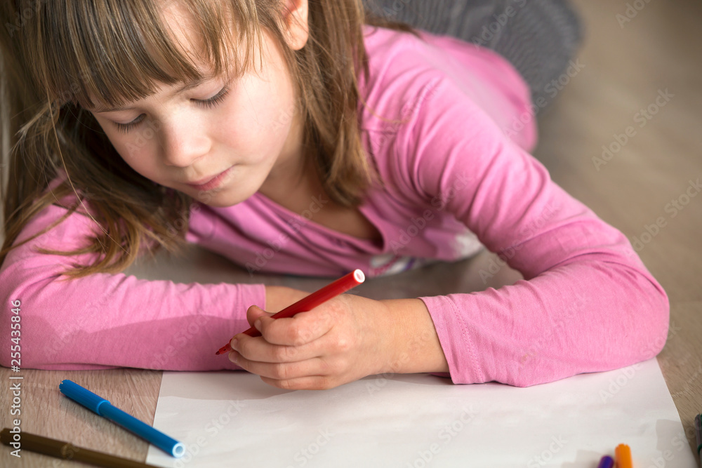 Cute child girl drawing with colorful pencils crayons on white paper. Art education, creativity concept. Cute child girl drawing with colorful pencils crayons on white paper. Art education, creativity concept.