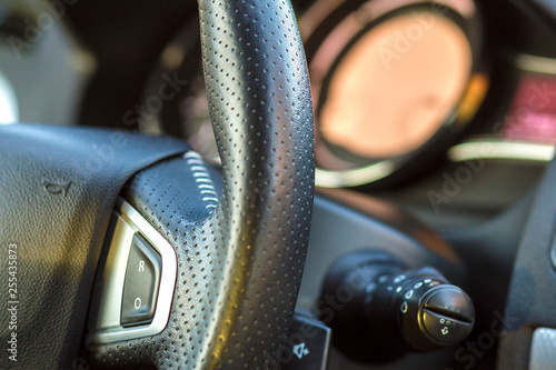 Luxurious car interior. Dashboard and steering wheel in black gray color. Transportation, design, modern technology concept.ultiple Values) photo