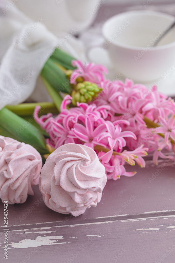 Traditional Russian homemade merengue marshmallow or zephyr on a plate with pink hyacinth on wooden background Traditional Russian homemade merengue marshmallow or zephyr on a plate with pink hyacinth on wooden background