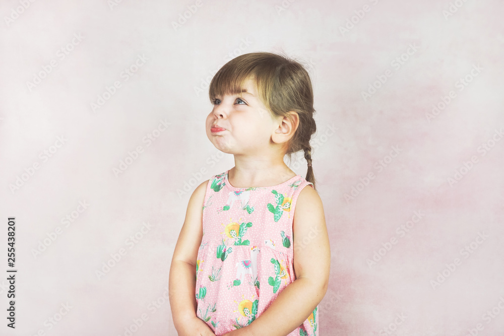 Fototapeta premium Young little and funny girl in a studio shot