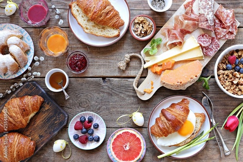 Canvas Print Easter festive brunch or breakfast set, meal variety with fried egg, sausage and cheese variety, croissants, granola, smoothie and dessert