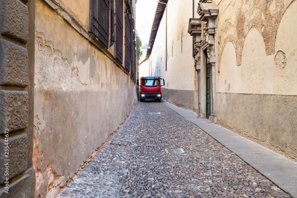 lorry truck on narrow medieval street in Italy