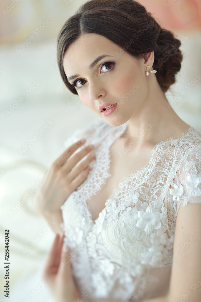 Young attractive female model girl before the wedding. Morning boudoir of the bride. Beautiful lingerie and white dress, delicate image Young attractive female model girl before the wedding. Morning boudoir of the bride. Beautiful lingerie and white dress, delicate image