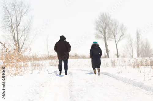 Elderly couple walking in winter