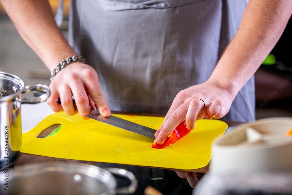 Cook cuts red pepper. Master class in the kitchen. The process of cooking. Step by step. Tutorial. Close-up Cook cuts red pepper. Master class in the kitchen. The process of cooking. Step by step. Tutorial. Close-up