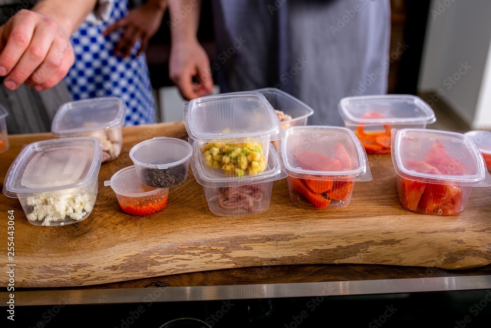 The cook lays out the jars with blanks of products for cooking. Master class in the kitchen. The process of cooking. Step by step. Tutorial. Close-up The cook lays out the jars with blanks of products for cooking. Master class in the kitchen. The process of cooking. Step by step. Tutorial. Close-up