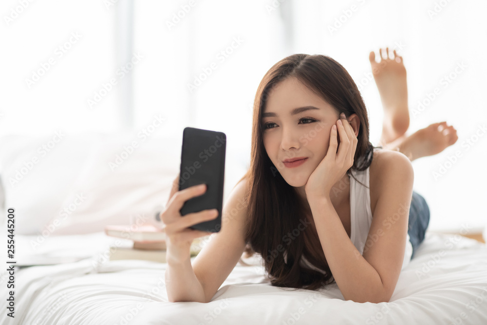 Happy Asian Beautiful female using cell phone. Happy Asian Beautiful female using cell phone.