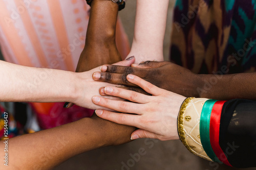 National diversity. People of different appearance and nationality stand in a circle together and hold hands. Team building and partnership business concept