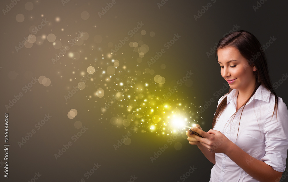 Person using phone with gold sparkling concept
Person using phone with gold sparkling concept