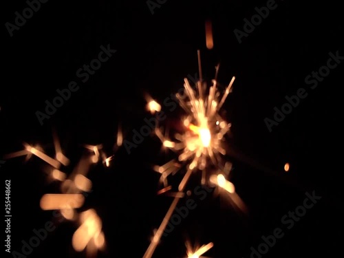 A slow motion of Bengali fire against the black background. Christmas pattern. Happy New Year