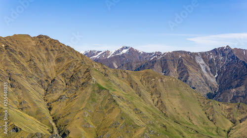 idillic landscape with mountain range, brown hills during sunny day, perfect hiking area, footpath leading into mountains 