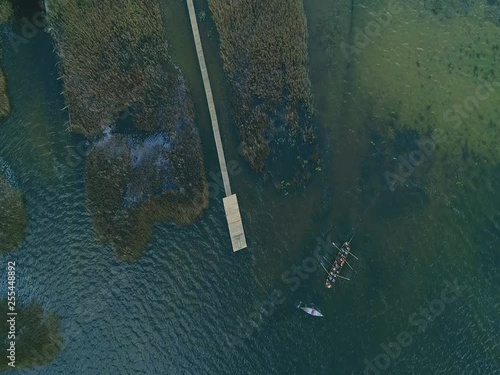 aerial shot of a kayak and long boat on lake in the fall
