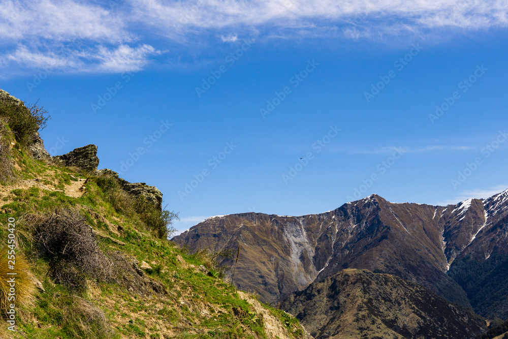 idillic landscape with mountain range, brown hills during sunny day, perfect hiking area