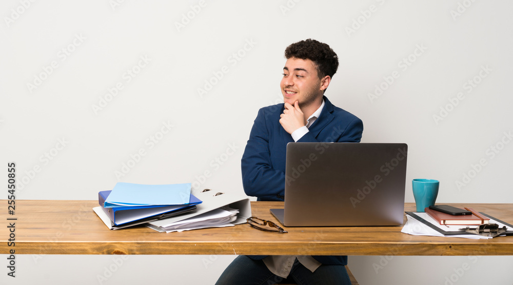 Business man in a office looking to the side Business man in a office looking to the side