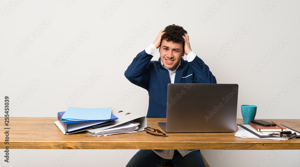 Business man in a office frustrated and takes hands on head Business man in a office frustrated and takes hands on head