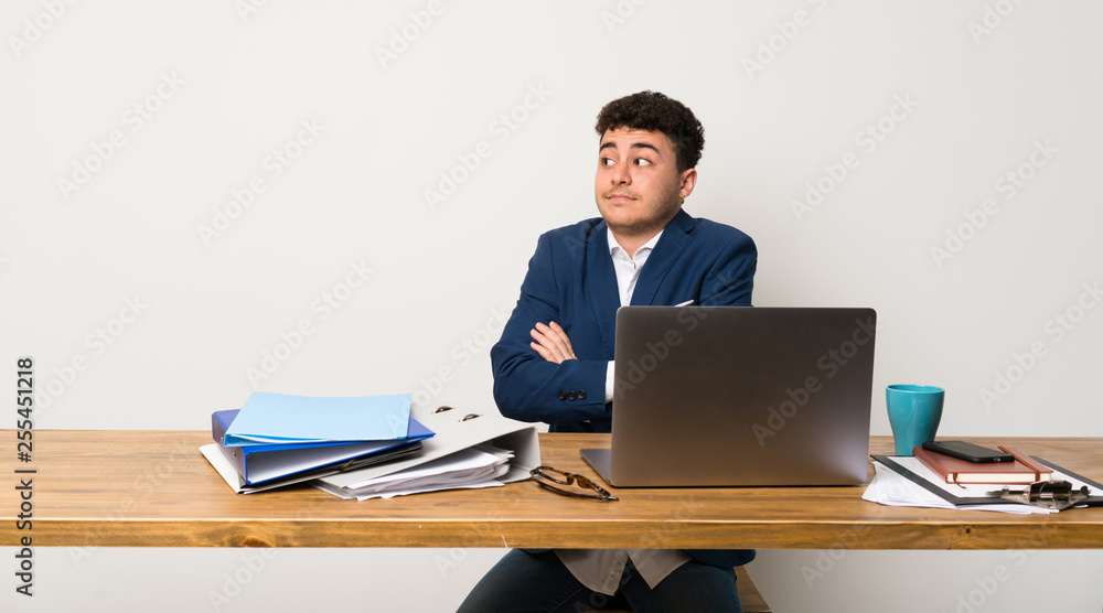 Business man in a office making doubts gesture while lifting the shoulders Business man in a office making doubts gesture while lifting the shoulders