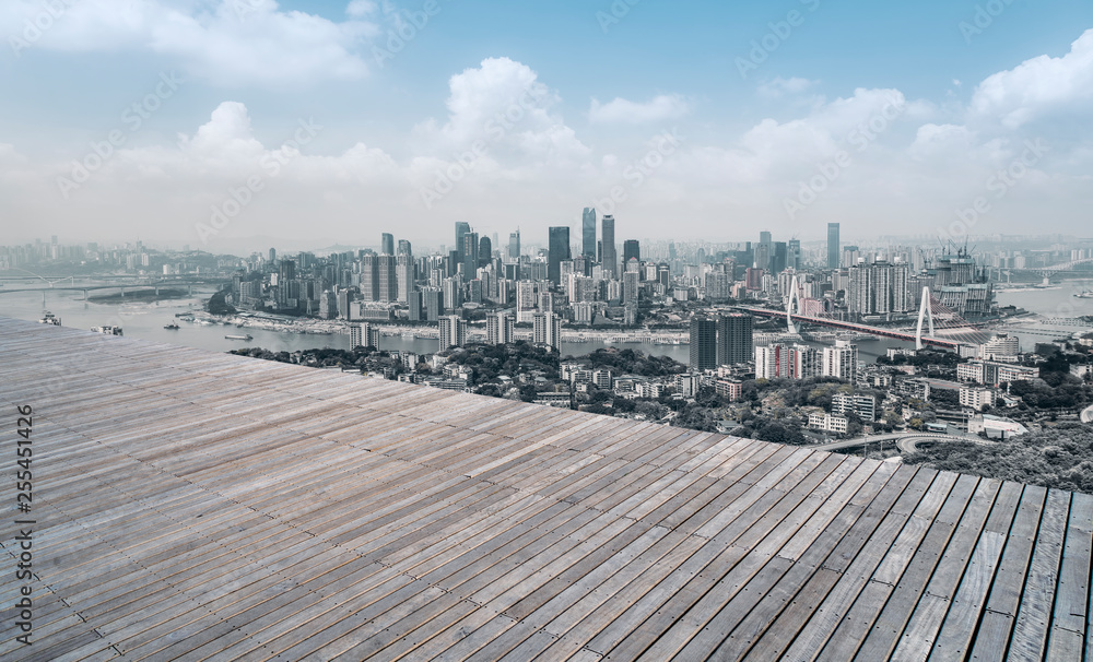 Naklejka premium Urban skyscrapers with empty square floor tiles