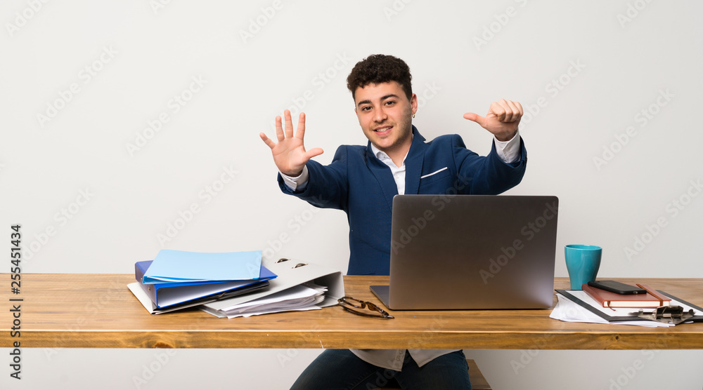Business man in a office counting six with fingers Business man in a office counting six with fingers
