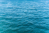 Blue turquoise transparent water surface of a sea ocean with waves
