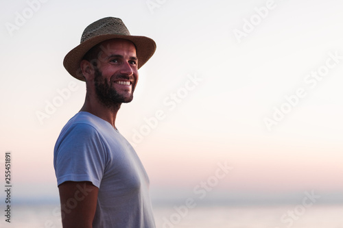 Portrait of a young man by the sea enjoying sunset © marjan4782