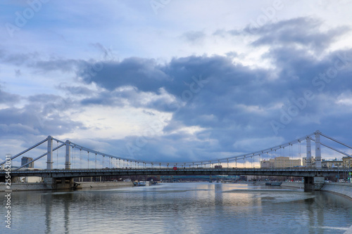 Krymsky Bridge or Crimean Bridge across the Moskva river in Moscow in the rays of setting sun in the evening blue hour 