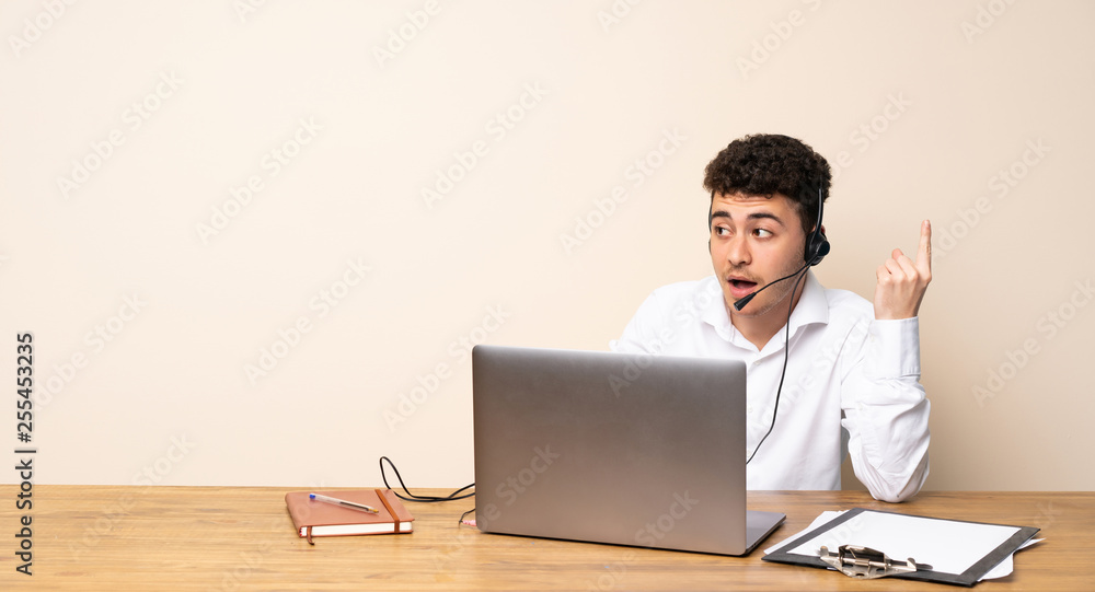 Telemarketer man thinking an idea pointing the finger up Telemarketer man thinking an idea pointing the finger up