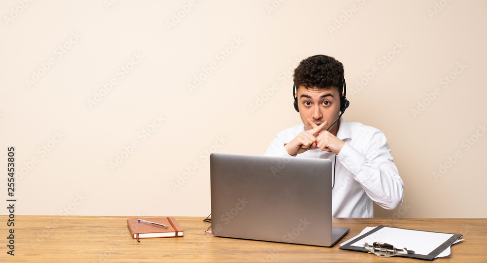 Telemarketer man showing a sign of silence gesture Telemarketer man showing a sign of silence gesture