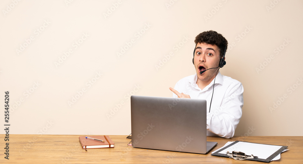 Telemarketer man surprised and pointing side Telemarketer man surprised and pointing side