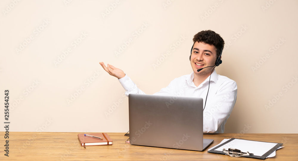 Telemarketer man presenting an idea while looking smiling towards Telemarketer man presenting an idea while looking smiling towards
